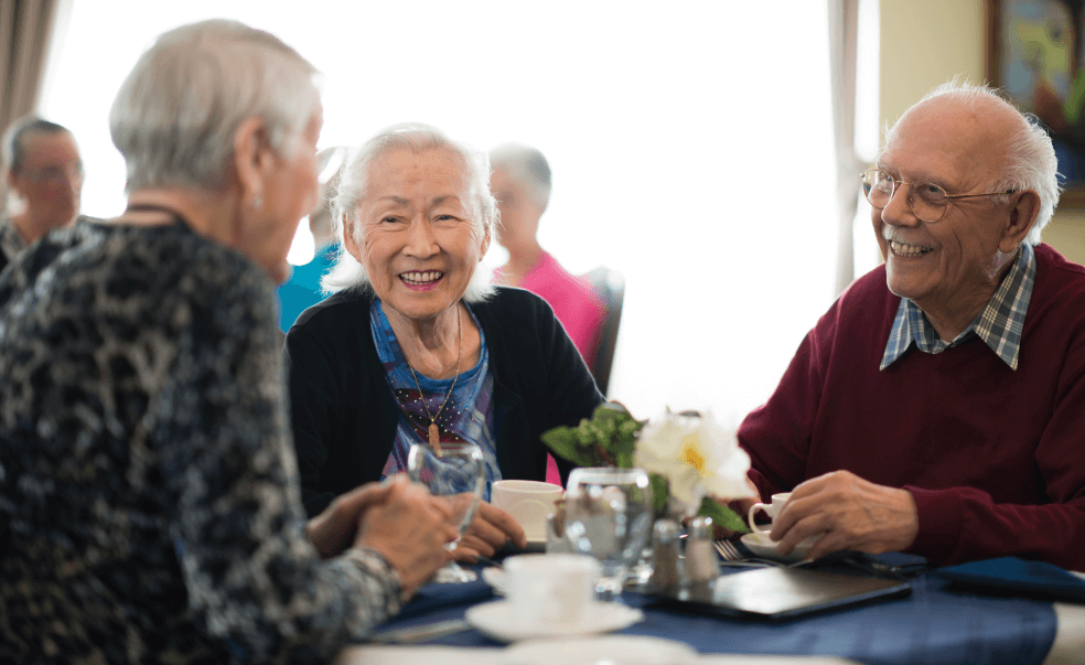 seniors talking at dining table