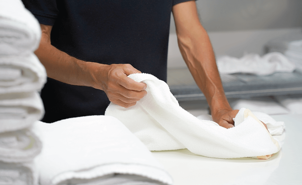 man folding towels