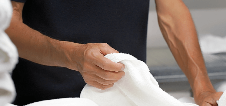 man folding towels