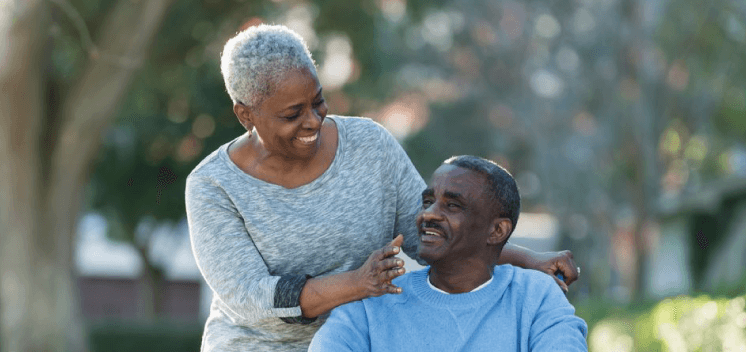 senior man in wheelchair with wife