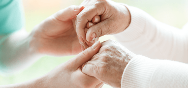 elder holding hands