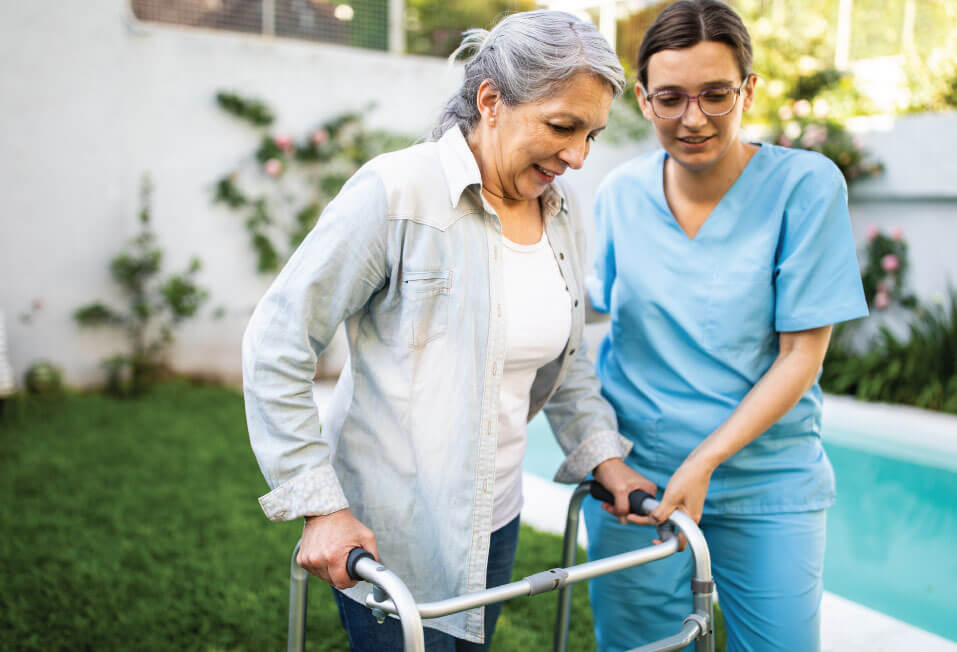 Nurse helping a senior with her walker