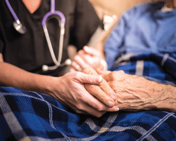 nurse and senior holding hands