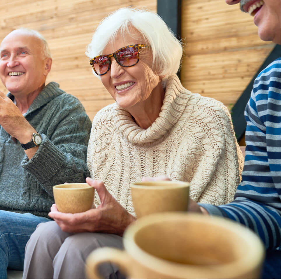 Senior Woman drinking coffee with friends