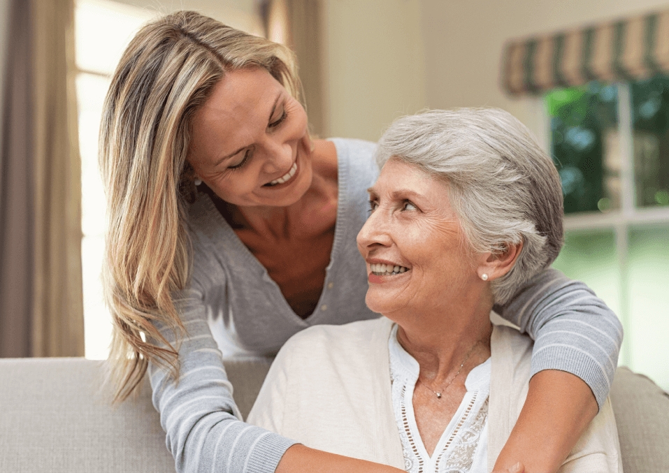 Woman hugging her elderly mother