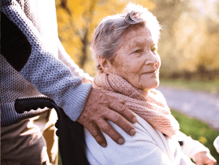 senior woman being pushed in her wheelchair