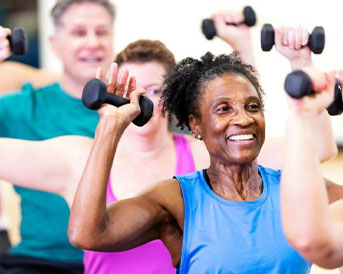 seniors in a work out class with weights