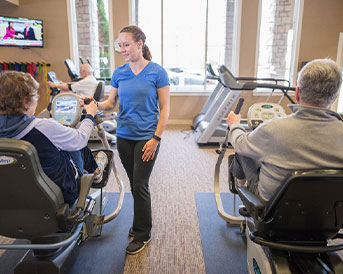 physical therapist with seniors in a gym
