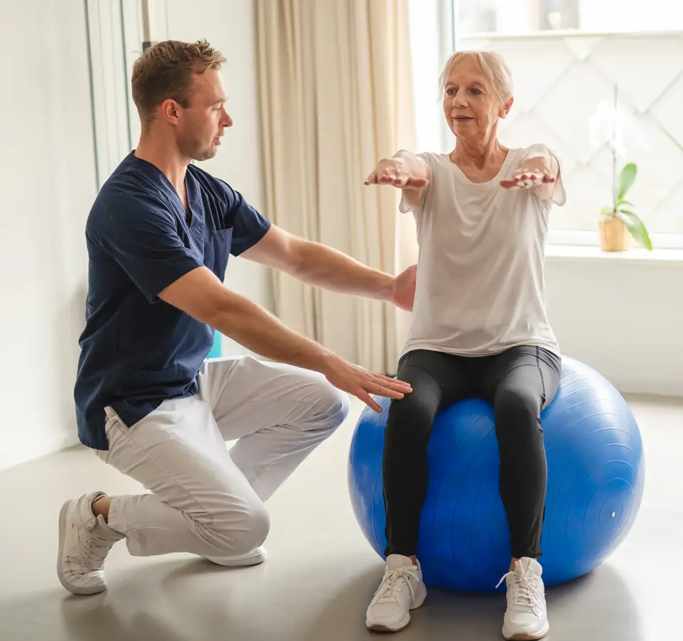 Senior man receiving physical therapy during outpatient rehab session in East Lansing, MI