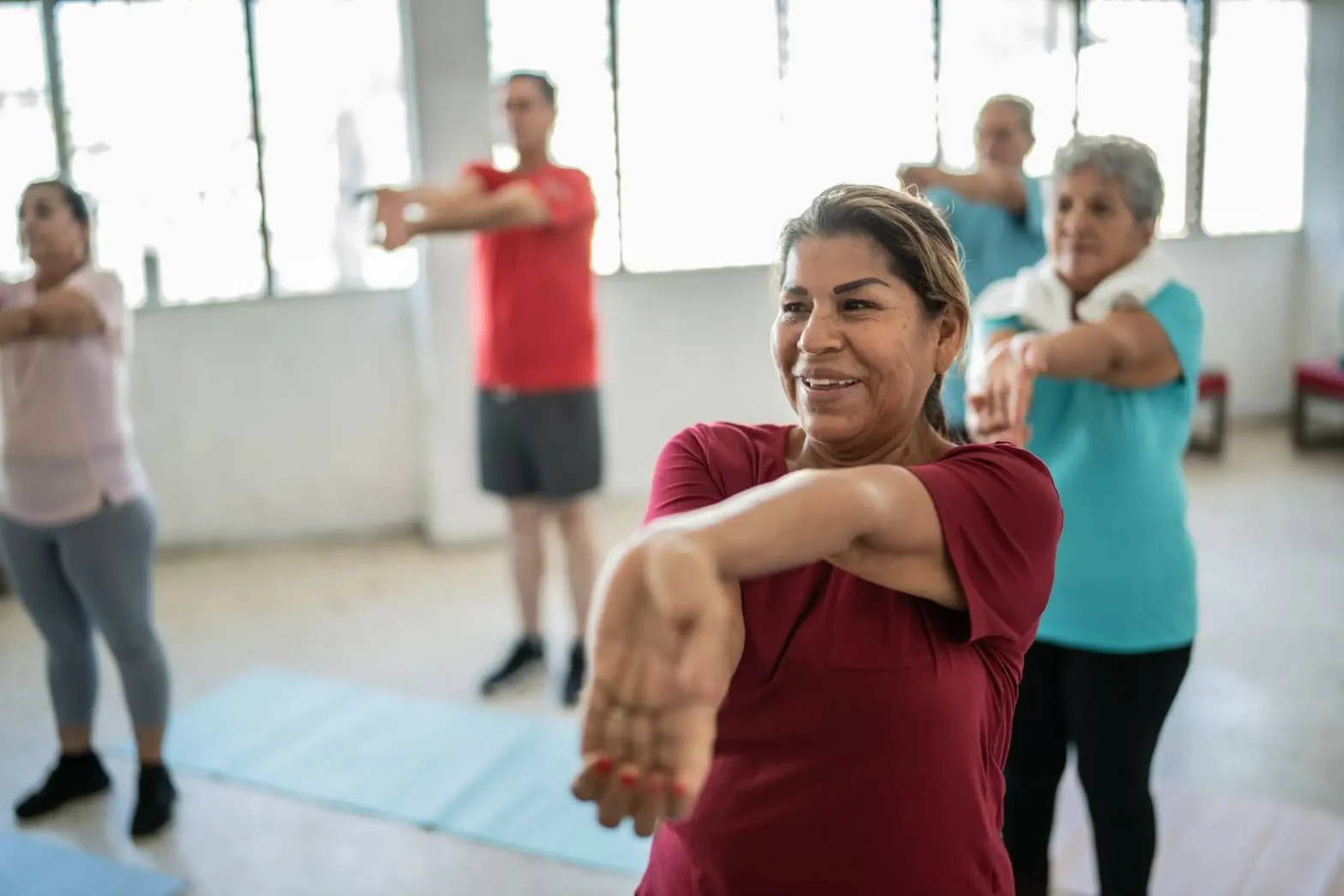 An elderly class on tai chi, one of the best exercises for seniors to improve mobility in senior living.